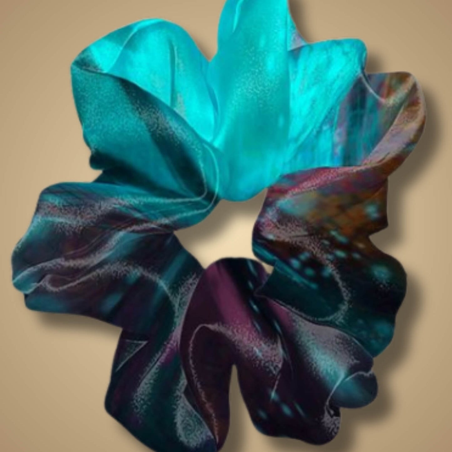 Closeup of the Sensory Overload scrunchie featuring bold, contrasting colors and energetic, layered patterns.