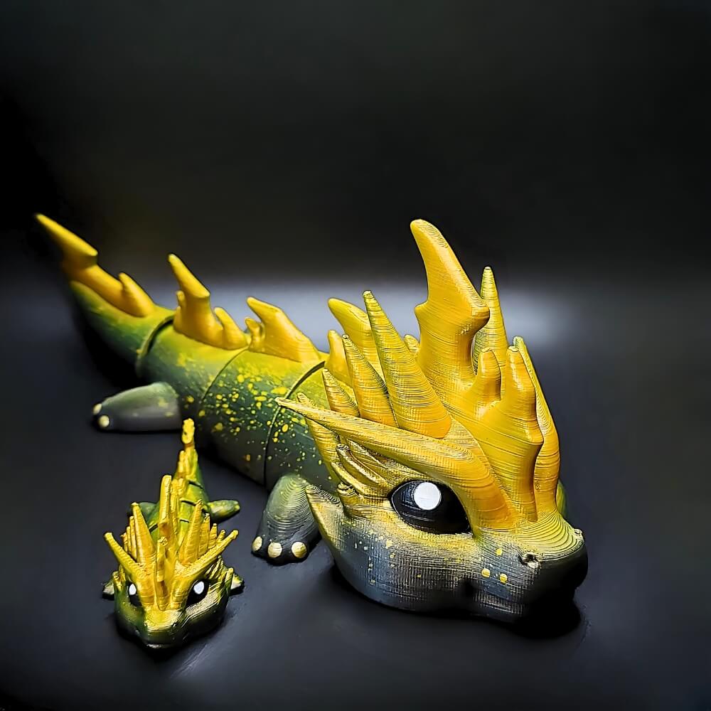 Close-up of two Zoryn Thunder Dragons, large and small, with bright yellow horns and hand-painted stormy textures.
