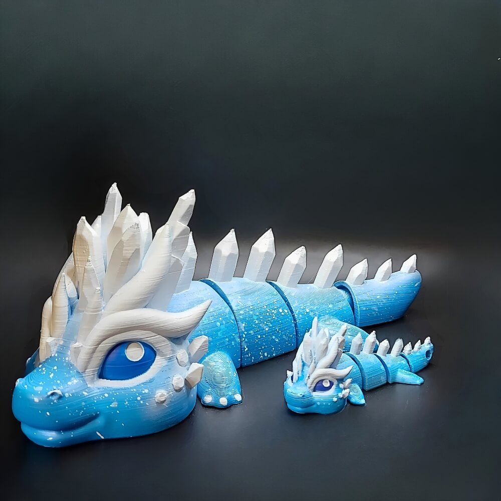 Large and small Eryndra Ice Dragons side by side, hand-painted in icy blue with white crystal details.