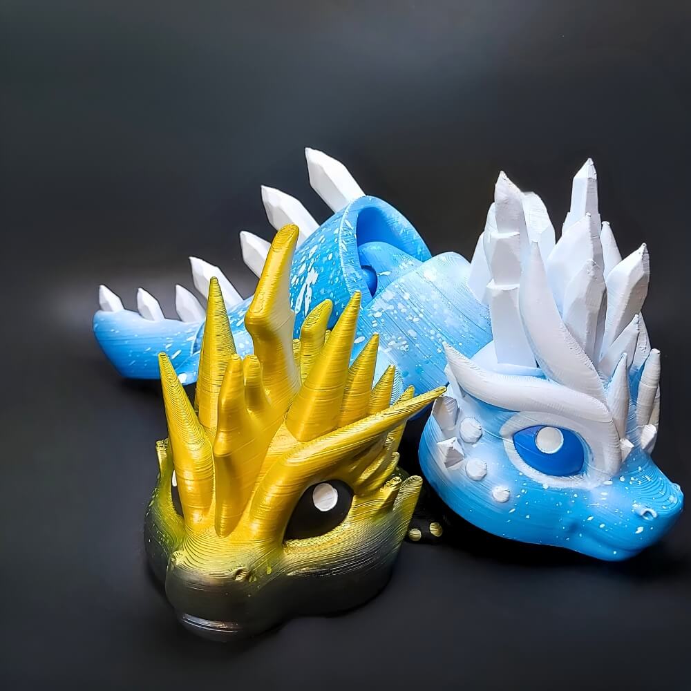 Eryndra and Zoryn Elemental Dragons side by side, hand-painted with ice blue and golden lightning details.