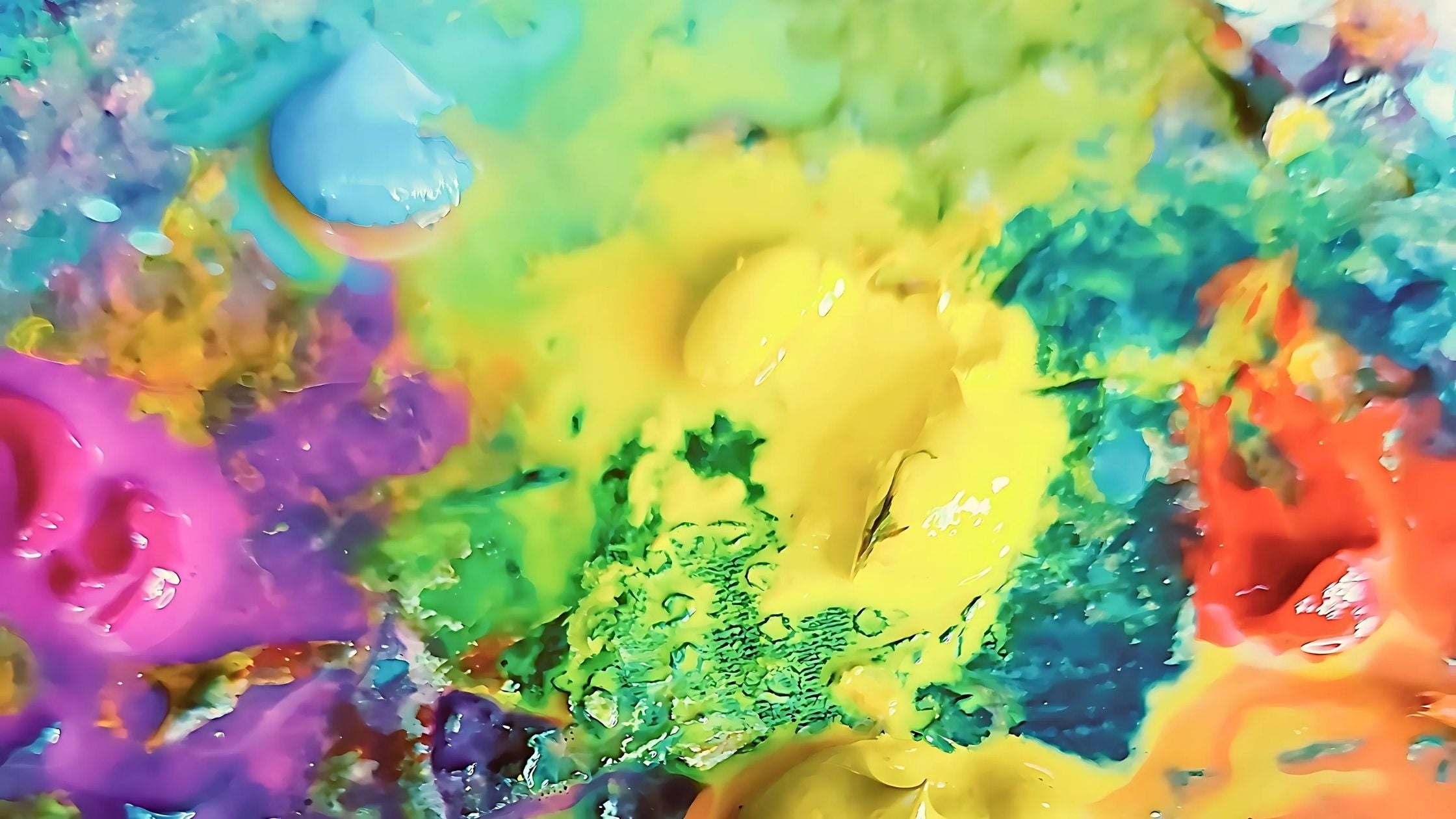 Colorful abstract wet paint palette with vibrant yellow, green, blue, and purple hues.