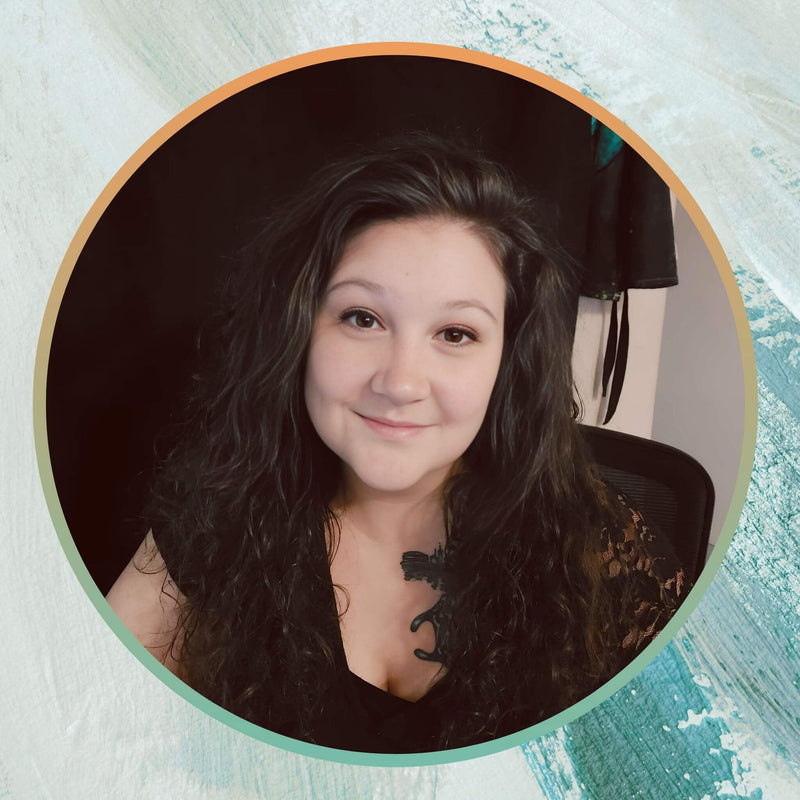 Headshot of Carolyne from Kylyne’s Custom Treasures, smiling at the camera in a black lace top, highlighting her friendly and artistic vibe.