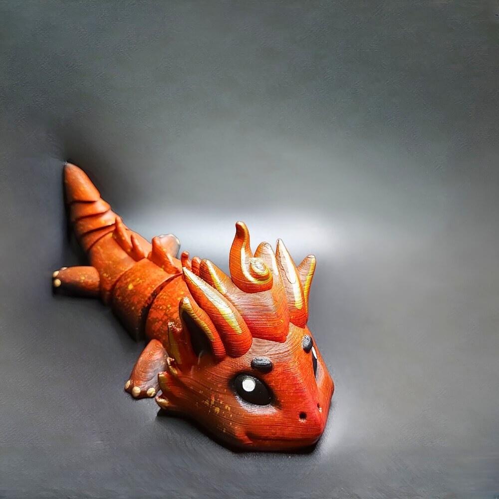 Handcrafted Fire Dragon Kaelix collectible keychain in red and orange, front view showing flame details