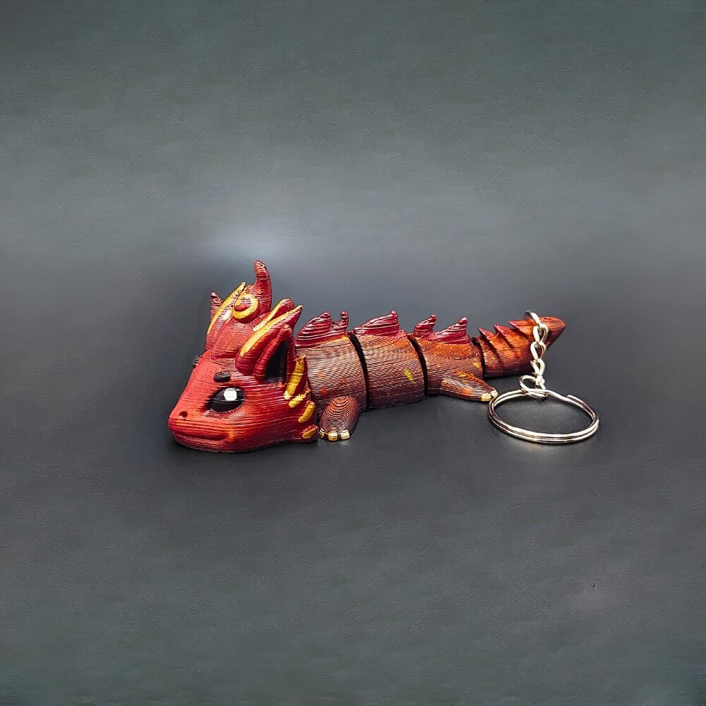 Side profile of Kaelix Fire Dragon keychain showing flame-inspired patterns