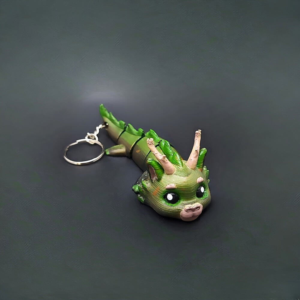 Handcrafted Forest Dragon Dasyra collectible keychain in green and brown, front view showing leaf patterns