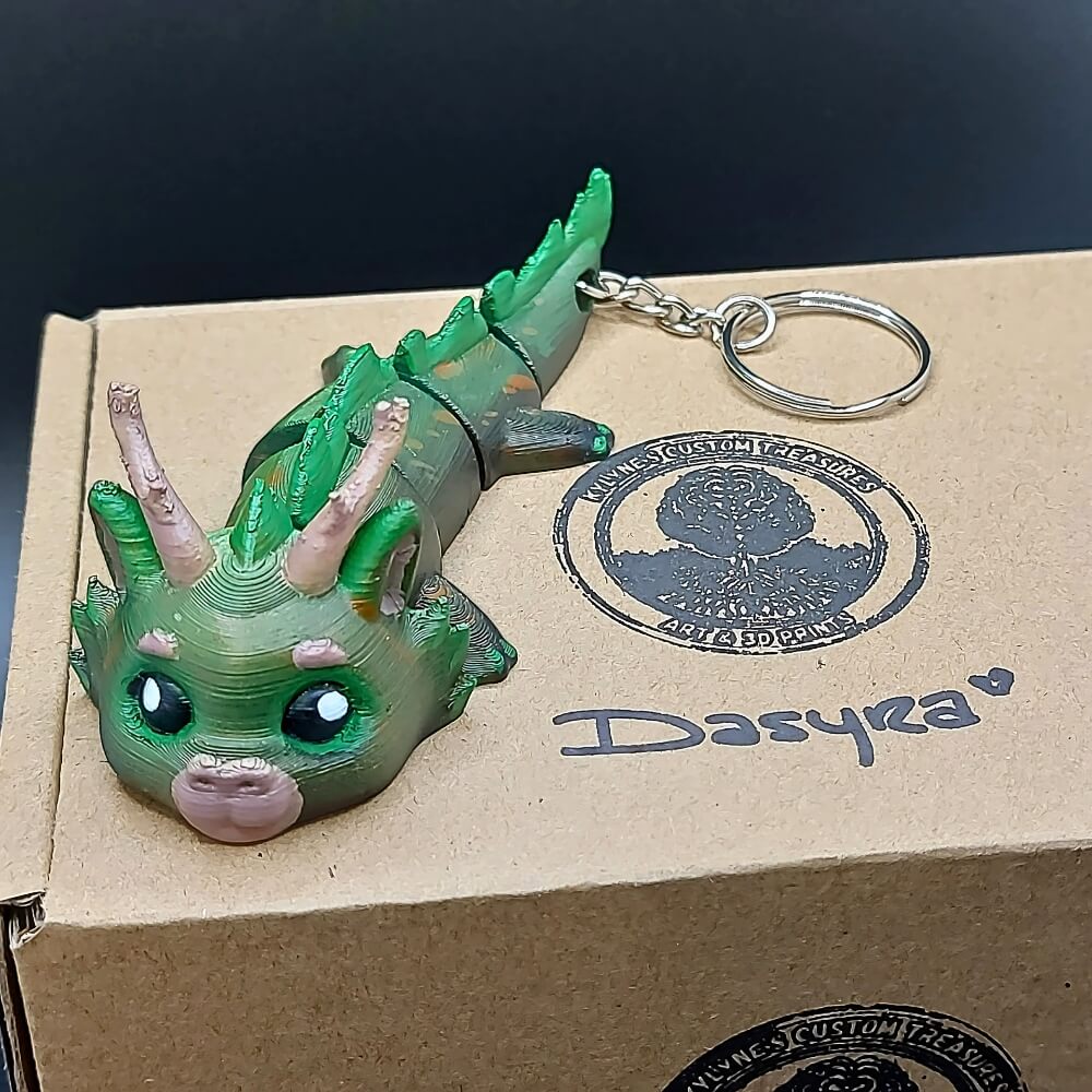 Dasyra Forest Dragon keychain with eco-friendly packaging and presentation box