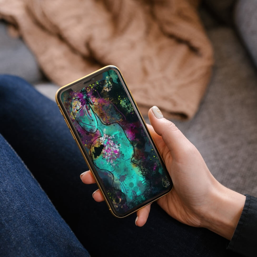 Person holding phone displaying Neuro-Spicy Brain original design digital wallpaper in cozy personal setting showing everyday use