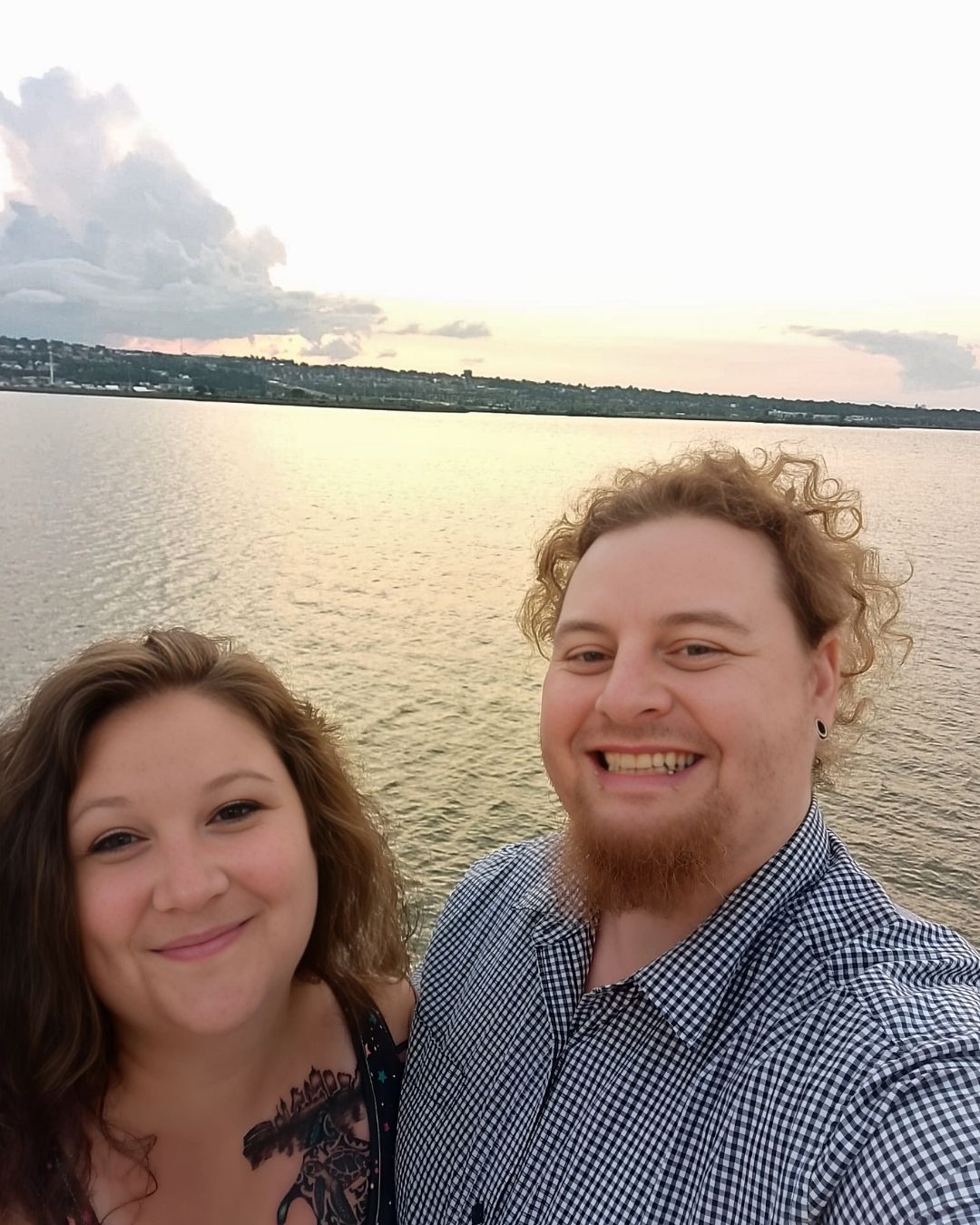Kyle and Carolyne smiling by the river in Quebec, enjoying a peaceful moment that reflects the heart behind Kylyne’s Custom Treasures.