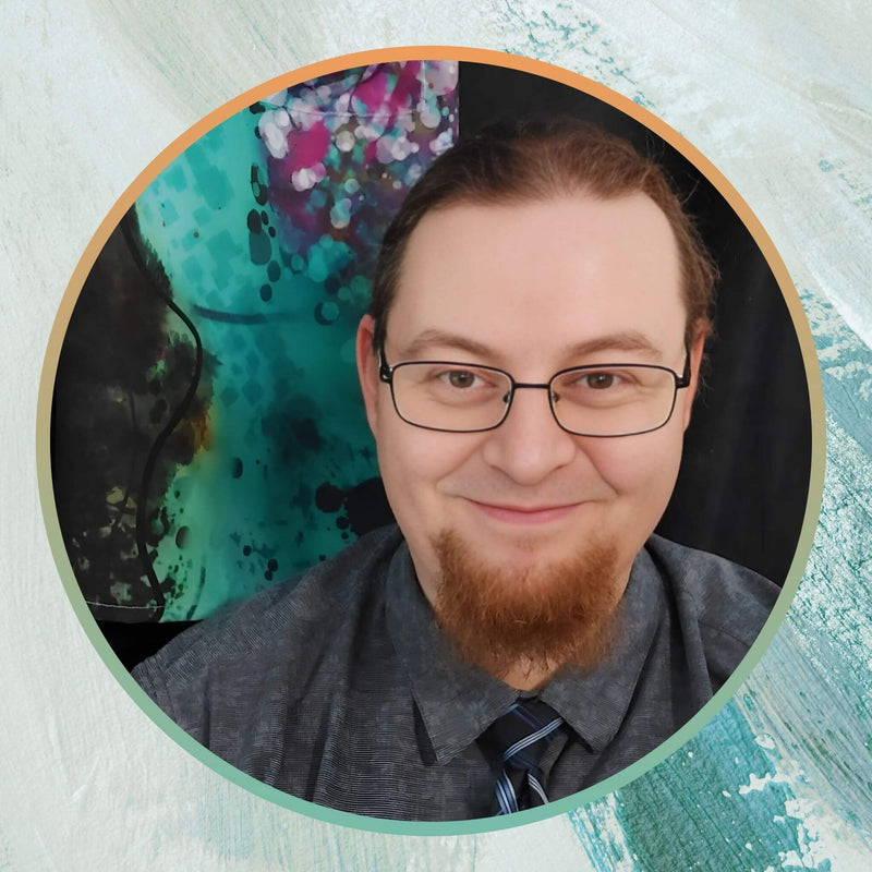 Headshot of Kyle, co-founder and 3D production specialist at Kylyne’s Custom Treasures, smiling and wearing glasses, a goatee, and a dress shirt, reflecting a professional and creative vibe.