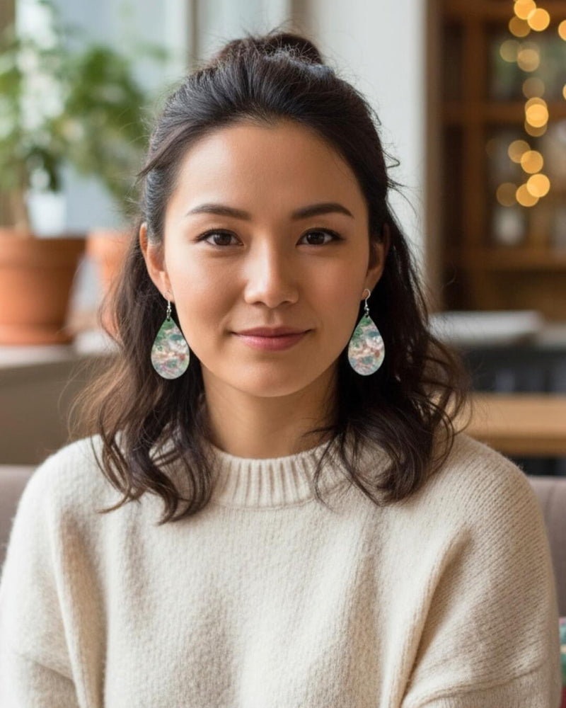 Model wearing a Mademoiselle Winter’s Dance earrings by Kylyne’s Custom Treasures and Le Galeriste, winter-inspired abstract art, portrait view.