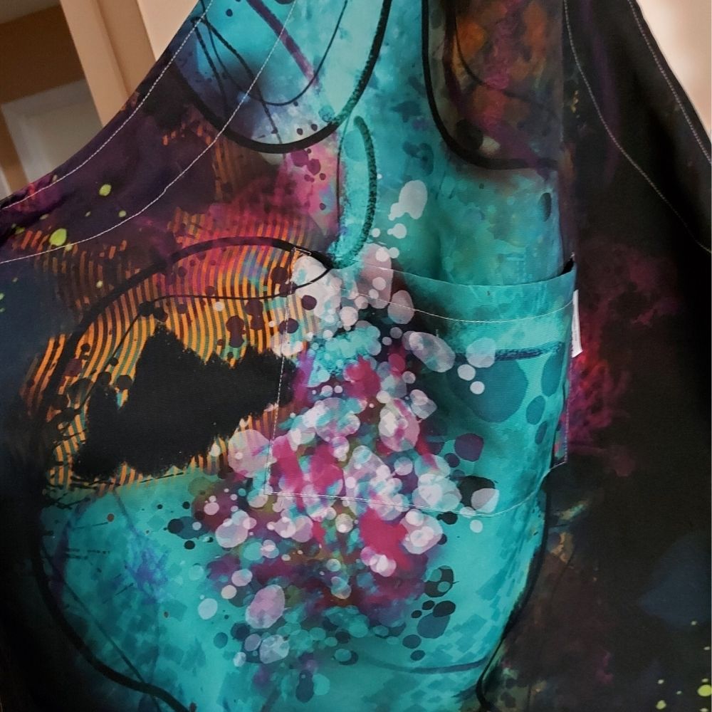 Close-up of the Neuro-Spicy Brain apron from Kylyne’s Custom Treasures, highlighting the abstract brushstroke textures and vibrant details