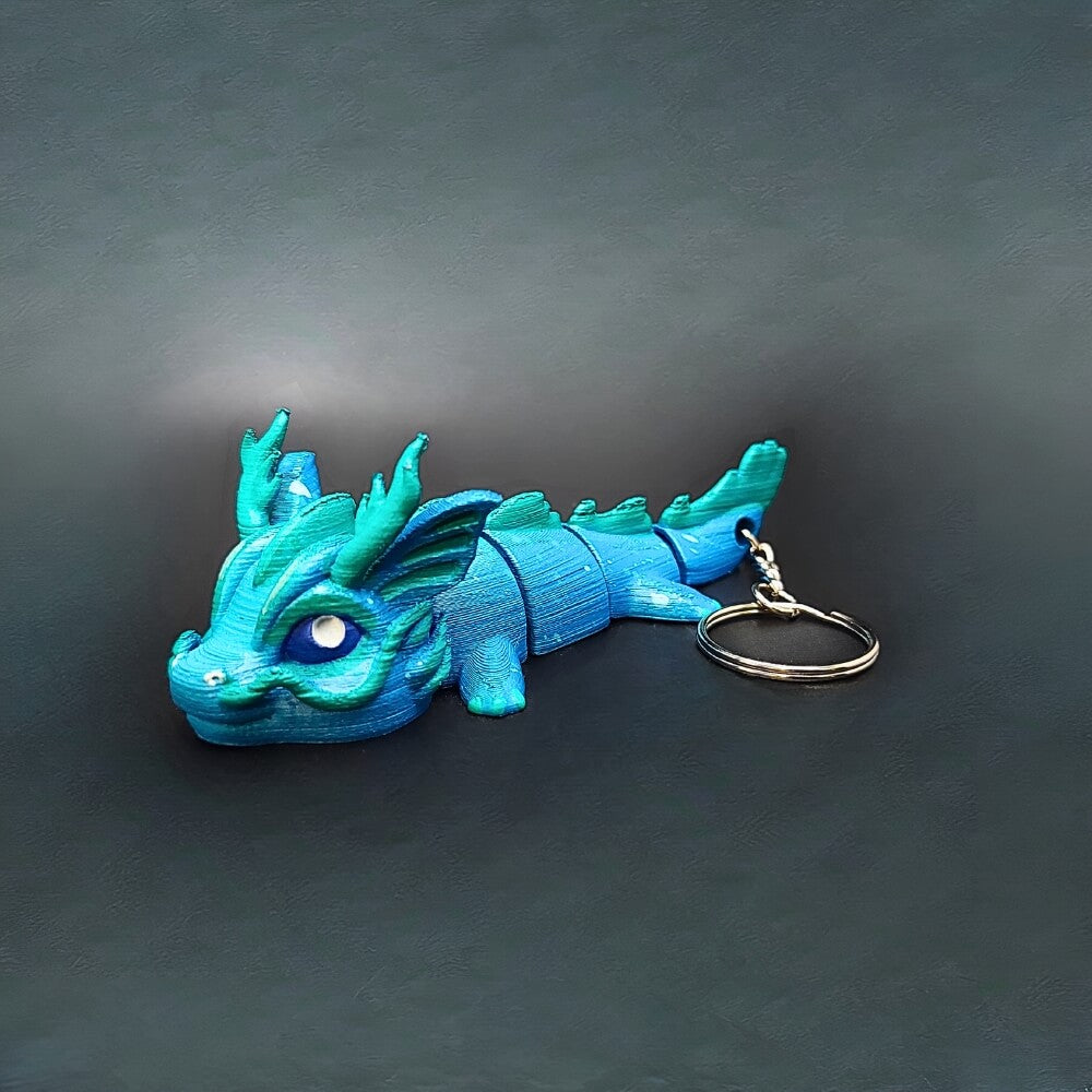 Side profile of Vaylen Sea Dragon keychain showing wave-inspired patterns