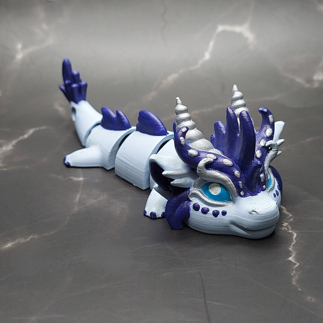 Zephir the Wind Elemental Dragon of Drakora, hand-painted and 3D-printed by Kylyne’s Custom Treasures, shown on a marble surface.